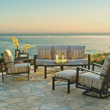 aluminum72-555 A patio furniture set with a view of the ocean.