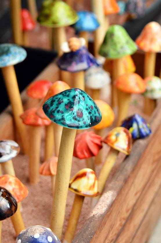 A group of colorful mushrooms in a wooden box.