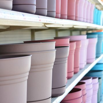 plastic-72-555-done A row of colorful pots on a shelf in a store.