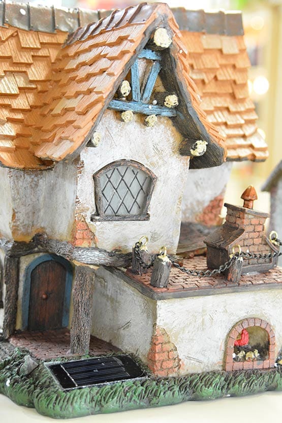 A model of a house with a roof and chimney.
