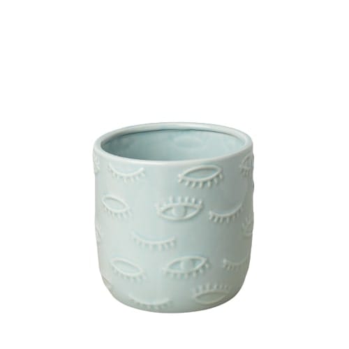 A blue ceramic planter with eyes on it, perfect for the best plant nursery near me.