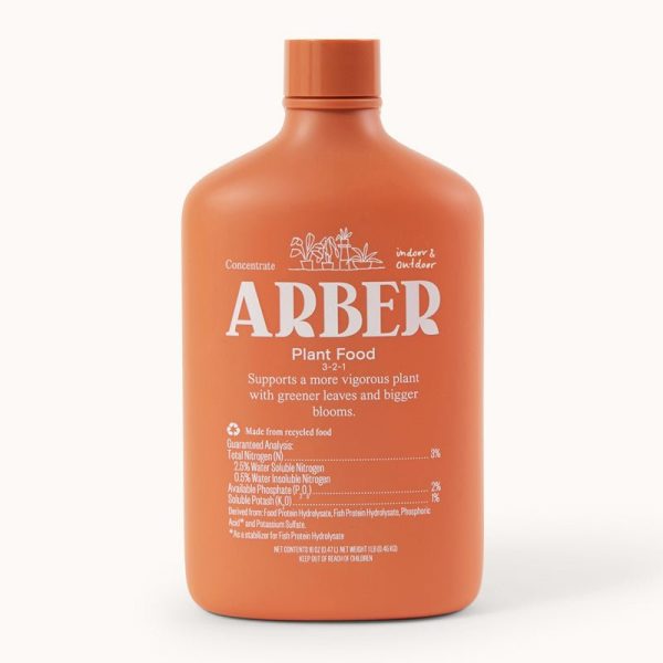 An orange bottle labeled "ARBER Plant Food 3-2-1" concentrate, for indoor and outdoor use, with information about nutrients and ingredients printed on the front.